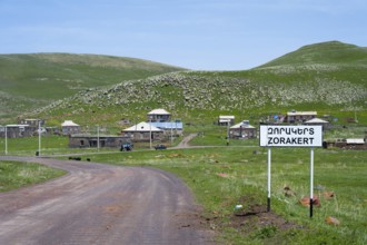 A country road leads to the village of Zorakert, surrounded by green hills and nature, Zorakert,