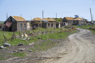 Quiet village with old buildings along a dirt road in a green landscape, Berdashen, Lake Arpi,