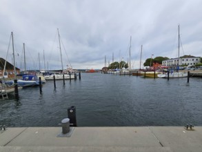 View of a harbour with several sailing boats and a cloudy sky in the background, Laboe, Kiel Fjord,