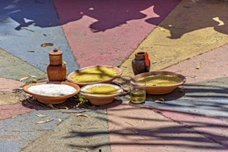 Food on a clay plate being offered to Exu in an Umbanda and Candomble party