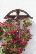 Crucifix with roses at the church of St. Ägidius and Nikolaus, Grainbach, Samerberg, Chiemgau,