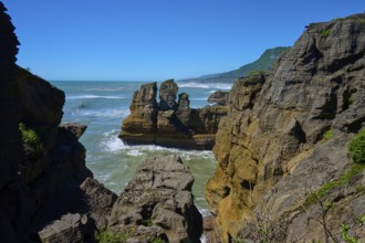 Rocky cliffs overlooking the sea under a clear blue sky, Pancake Rocks, Westport, Greymouth, West