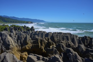 Rough sea meets impressive stacked cliffs under a vast sky, Pancake Rocks, Westport, Greymouth,