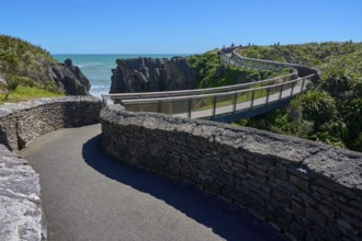 Extensive stone paths lead over a bridge past cliffs overlooking the sea, Pancake Rocks, Westport,