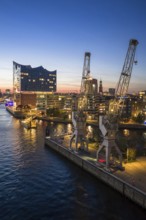 Aerial view of the Elbphilharmonie with Sandtorkai and historic cranes at the blue hour, Hamburg,