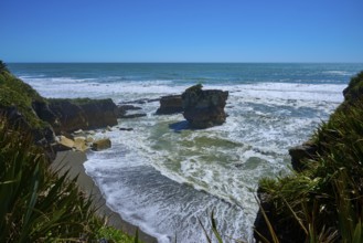 Breathtaking coastal landscape with rocks in the sea under a bright blue sky, Pancake Rocks,