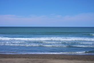 Calm beach with gentle waves on the blue horizon, Mana Bay, Patea, Taranaki, North Island, New