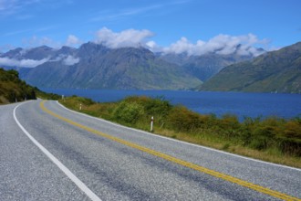 Winding road along a lake with mountains in the background, Devil's Staircase Lookout Point,