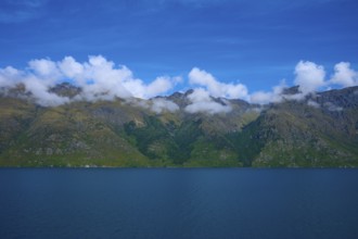 Tranquil landscape with mountains and a deep blue lake under a clear sky, Devil's Staircase Lookout