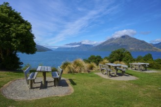 Picnic tables with a view of a lake and mountains below, Drift Bay, Lake Wakatipu, Queenstown-Lakes