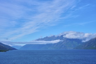 Tranquil landscape with mountains, blue lake and slightly cloudy sky, Drift Bay, Lake Wakatipu,