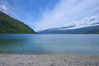 Peaceful beach landscape with blue sky and calm water, Kingston, Queenstown-Lakes District, Otago,