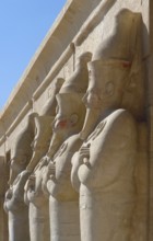 Architectural detail of the Mortuary Temple of Hatshepsut in Egypt with stone sculptures in a row
