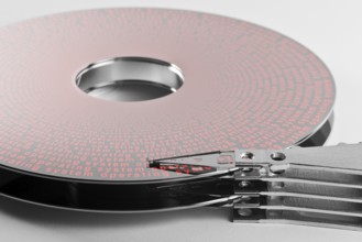 Detail shot of a separated hard disk platter with actuator arm in light grey backAllegory theme