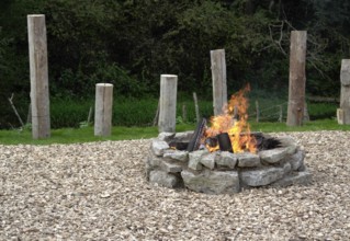 Outdoor fireplace with burning fire