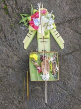 Sacrifice object on stony ground seen in Bali, Indonesia