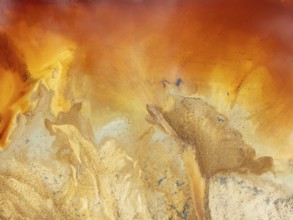 Abstract patterns in a pool in the mineral-rich area of the Rio Tinto mines. The colour is caused