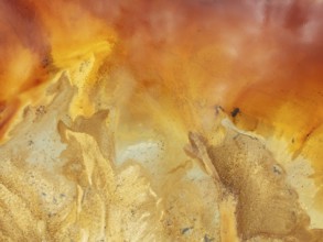 Abstract patterns in a pool in the mineral-rich area of the Rio Tinto mines. The colour is caused