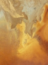 Abstract patterns in a pool in the mineral-rich area of the Rio Tinto mines. The colour is caused