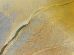 Abstract patterns in a waste pond in the mineral-rich area of the Rio Tinto mines. The colour is