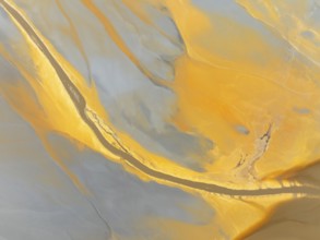 Abstract patterns in a waste pond in the mineral-rich area of the Rio Tinto mines. The colour is