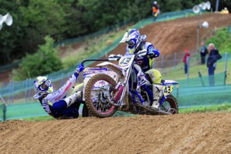Motocross, Rudersberg, Baden-Württemberg, Germany, Europe, Two riders on a motorbike cross a hill