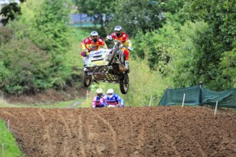 Motocross, Rudersberg, Baden-Württemberg, Germany, Europe, Rider team flies with a motorbike with