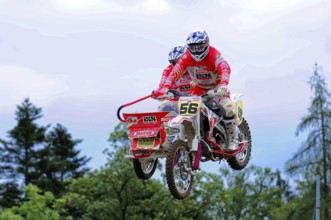 Motocross, Rudersberg, Baden-Württemberg, Germany, Europe, Motorcyclists in red suits during a jump