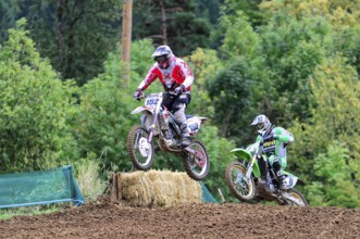Motocross, Rudersberg, Baden-Württemberg, Germany, Europe, Two motocross riders jump over a mound