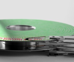 Detail shot of a hard disk platter with actuator arm and symbolic data error processing