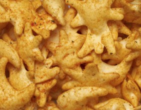 Full frame closeupof some baked crisp salty snack pieces
