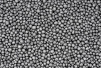Full frame closeup showing lots of dark polystyrene beadlets