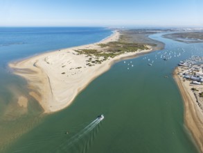 The large sandbar of Punta del Boquerón and partial view of the fishing village of Sancti Petri. In