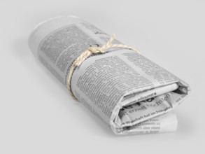 Rolled german newspaper in grey back