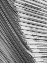 Full frame background with lots of stacked newspapers
