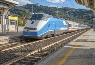 Train at a railway station in Oneglia, a former town in northern Italy on the Ligurian coast, in