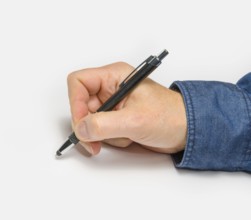 Male hand with ball pen in light back