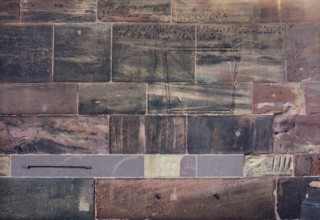 Historic engravings on a stone wall at the Freiburg Minster in Freiburg im Breisgau, a city in