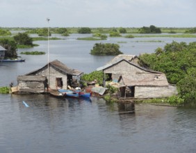 Waterside scenery with rural houses at the Tonle Sap, a river in Cambodia