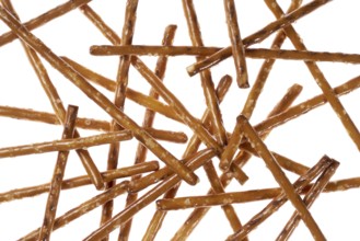 Closeup of some crossed salt sticks in white back