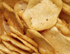 Full frame closeupof some baked crisp salty snack pieces