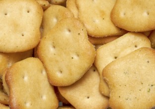 Full frame closeupof some baked crisp salty snack pieces