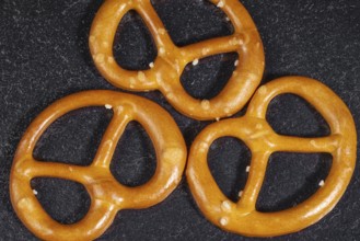 Closeup of some lye pretzels in dark back