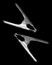 Studio photography of two metal clamps isolated on black