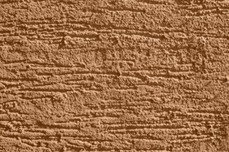 Full frame background showing brown rough plaster