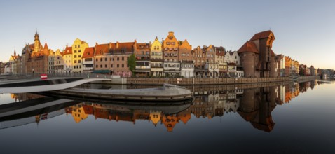 Panorama of the waterfront promenade with reflection at sunrise in the Old Town, Motlawa River,