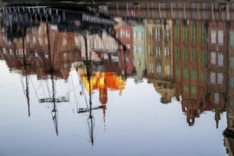 Waterfront promenade with reflection at sunrise in the Old Town, Motlawa River, Gdansk, Gdansk,