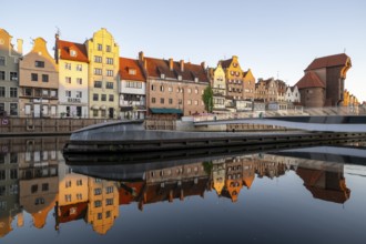 Waterfront promenade with reflection at sunrise in the Old Town, Motlawa River, Gdansk, Gdansk,