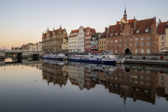 Waterfront promenade with reflection at sunrise in the Old Town, Motlawa River, Gdansk, Gdansk,