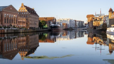 Waterfront promenade with reflection at sunrise in the Old Town, Motlawa River, Gdansk, Gdansk,
